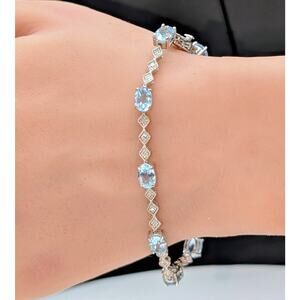 Nine Blue Topaz Silver Tone Tennis Bracelet